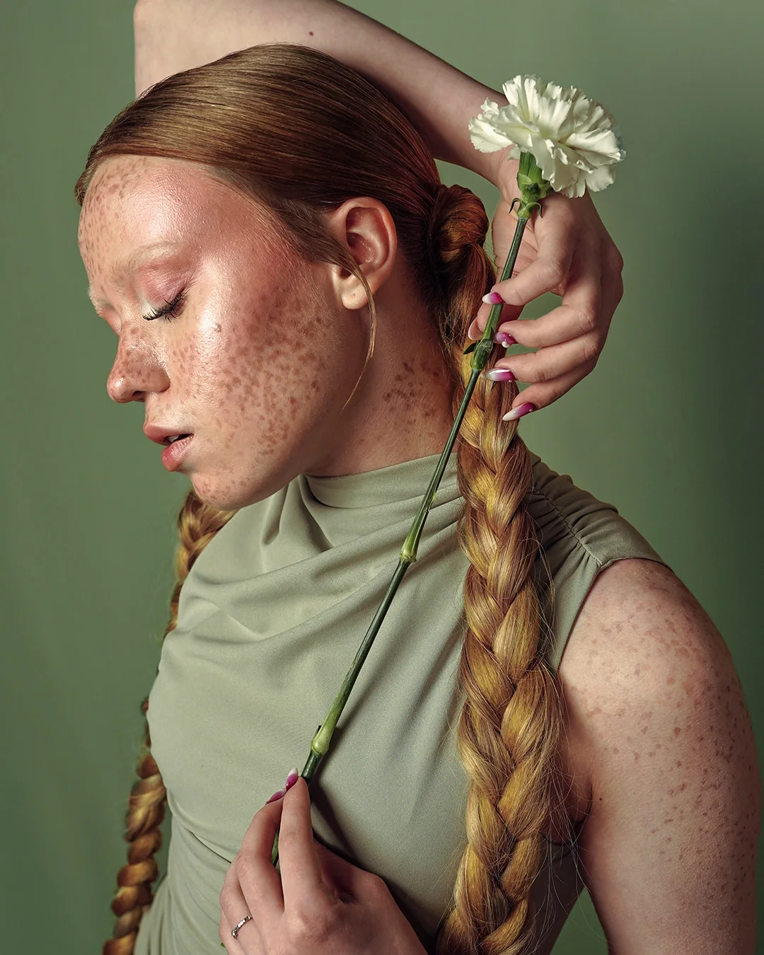 Profile portrait with a white flower and a long braid