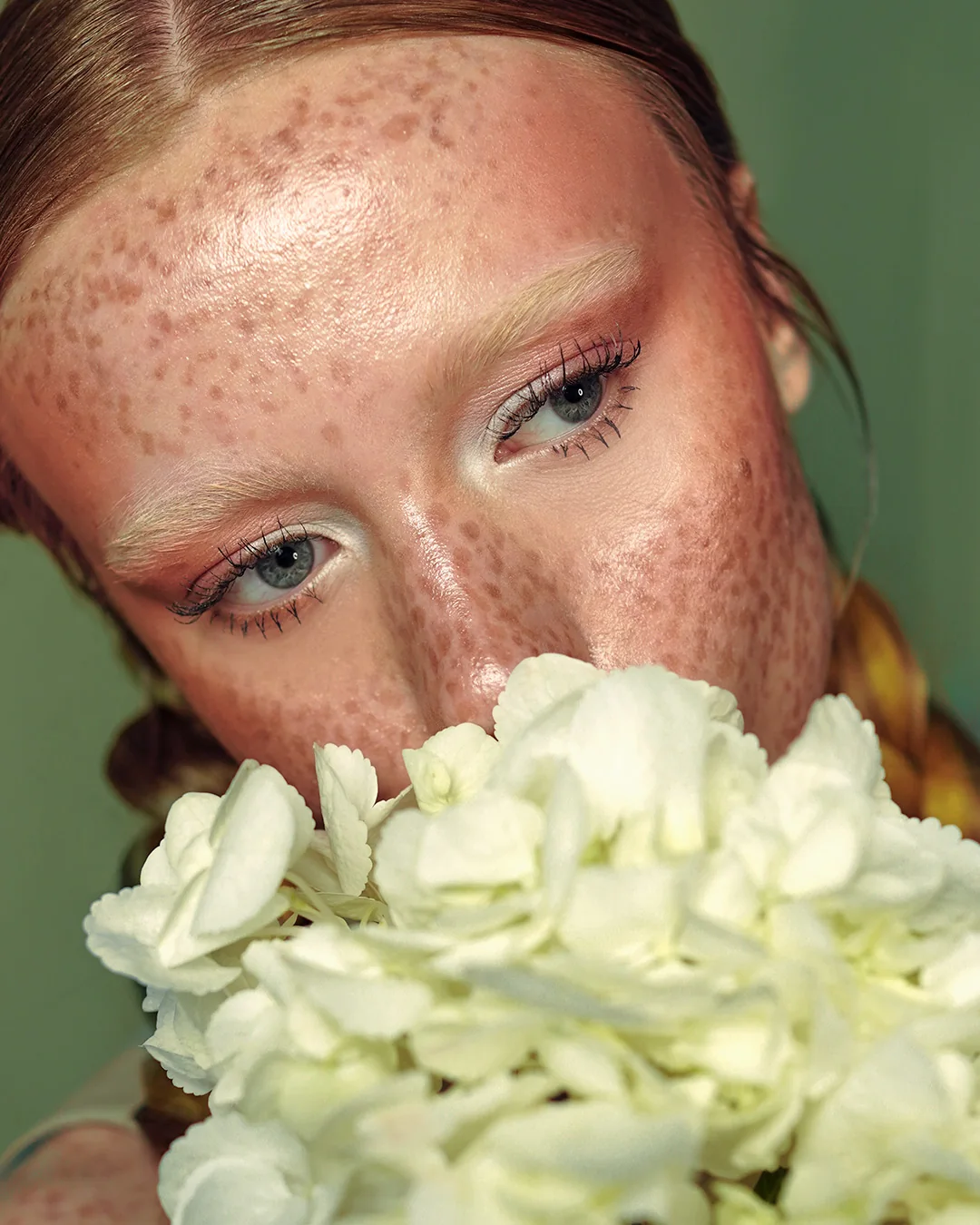 Close portrait with freckles and hydrangeas