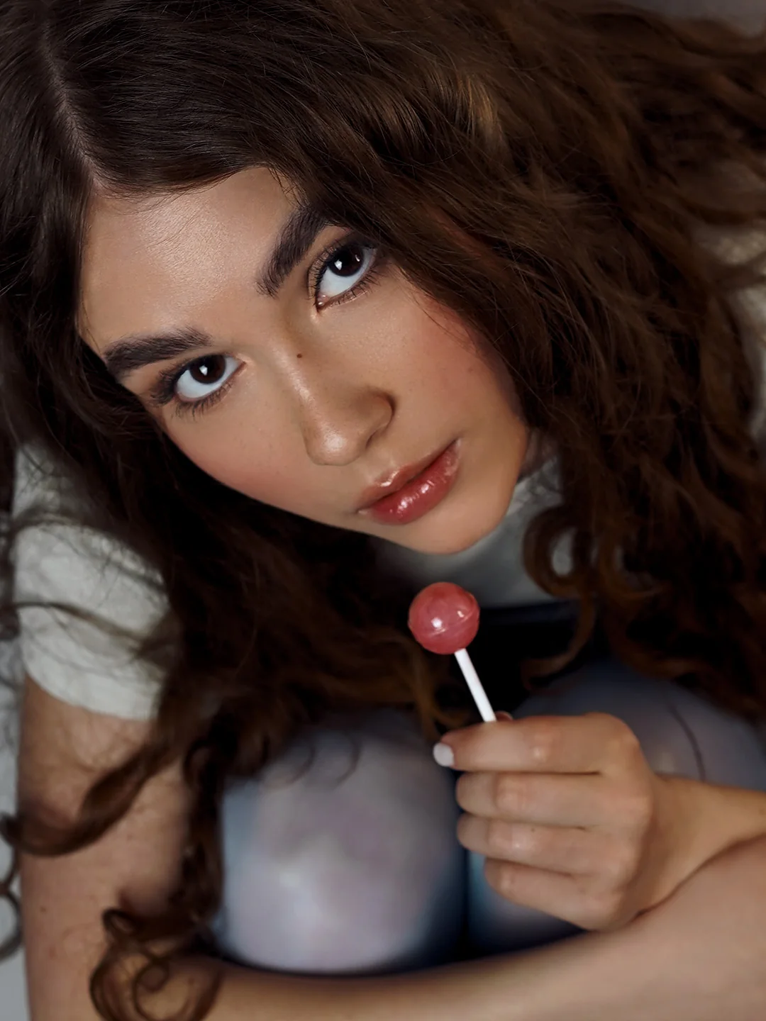 Portrait lying down with a lollipop