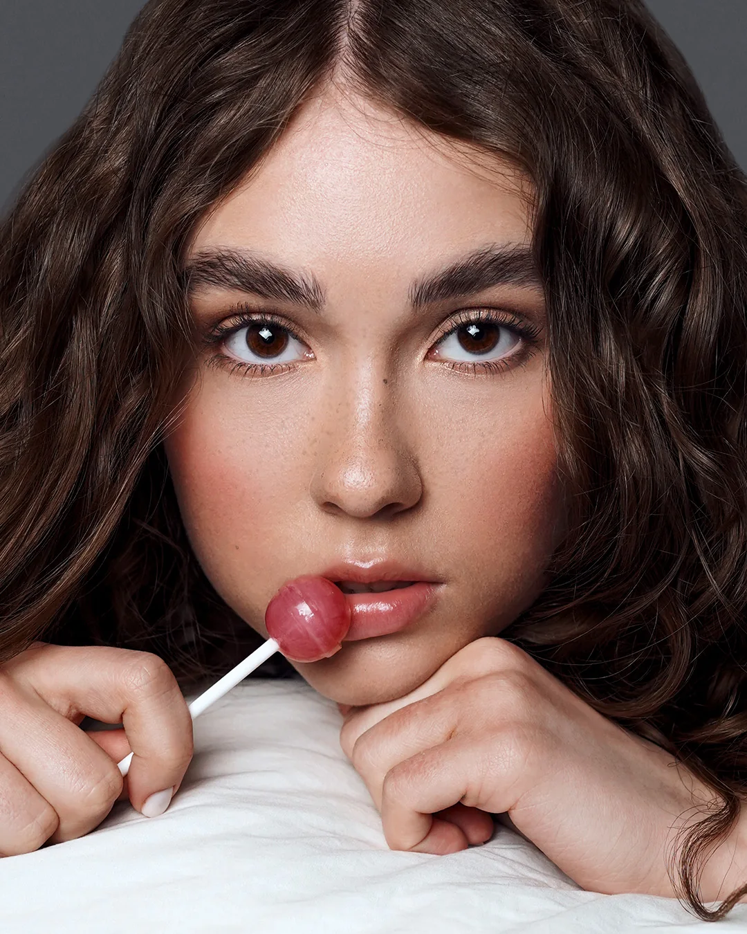 Close portrait, lollipop at the lips